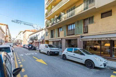 two cars parked on the side of a city street at Cosy Studio at Nice Port in Nice