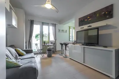 a living room with a couch and a flat screen tv at Cosy Studio at Nice Port in Nice