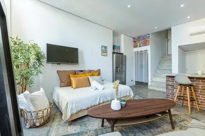 a living room with a bed and a table at Cosy Studio in the Old Town near Garibaldi Square in Nice