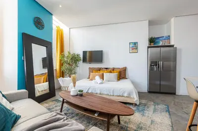 a bedroom with a bed and a coffee table at Cosy Studio in the Old Town near Garibaldi Square in Nice