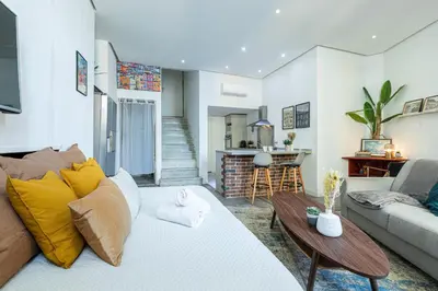 a living room with a couch and a table at Cosy Studio in the Old Town near Garibaldi Square in Nice