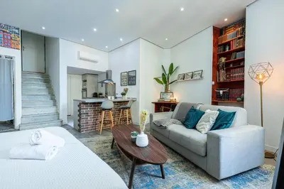 a living room with a couch and a table at Cosy Studio in the Old Town near Garibaldi Square in Nice