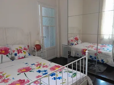 a bedroom with two beds with flowers on them at Les Palmiers NiceAirport, Beach200m, 2bedrooms, Wifi Optic in Nice