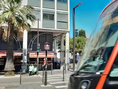 a bus on a city street with a traffic light at Les Palmiers NiceAirport, Beach200m, 2bedrooms, Wifi Optic in Nice