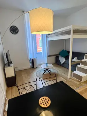 a living room with a dining table and a bunk bed at Jean in Nice