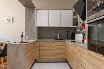 a kitchen with white cabinets and a counter top at MY CASA - JOFFRE 49-D - Charming 2 bedroom - Carré d'Or in Nice