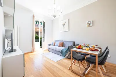a living room with a table and a couch at MY CASA - JOFFRE 49-D - Charming 2 bedroom - Carré d'Or in Nice