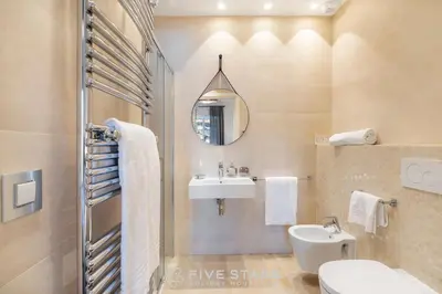 a bathroom with a sink and a toilet and a mirror at Villa Artemys - Five Stars Holiday House in Saint-Jean-Cap-Ferrat