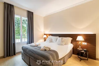 a bedroom with a large bed with two towels on it at Villa Artemys - Five Stars Holiday House in Saint-Jean-Cap-Ferrat