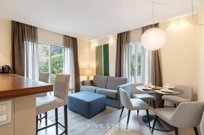 a kitchen and living room with a table and chairs at Villa Artemys - Five Stars Holiday House in Saint-Jean-Cap-Ferrat