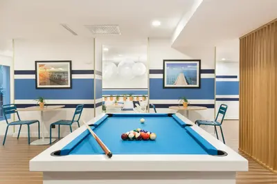 a pool table in a room with blue walls at The Deck Hotel by Happyculture in Nice