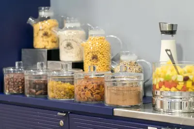 a counter with many jars of different types of food at The Deck Hotel by Happyculture in Nice