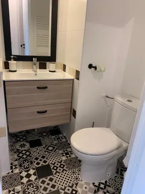a bathroom with a white toilet and a sink at Appartement agréable en bord de mer in Villefranche-sur-Mer