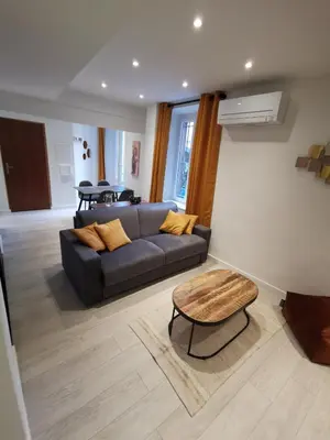 a living room with a couch and a table at Appartement Vieux-Nice N in Nice