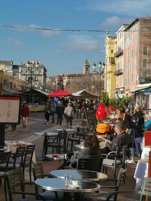 a group of people sitting at tables in a city at Appartement Vieux-Nice N in Nice