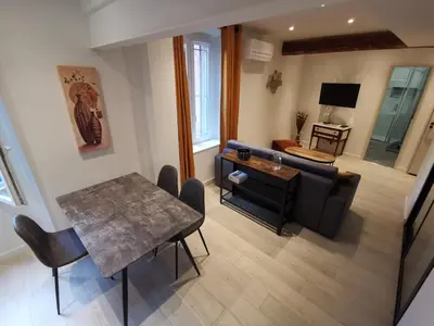 a living room with a table and a couch at Appartement Vieux-Nice N in Nice
