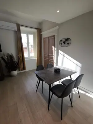 a dining room with a table and some chairs at Appartement Vieux Nice S in Nice