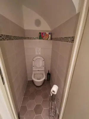 a small bathroom with a toilet in a stall at Appartement Vieux Nice S in Nice