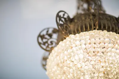 a beaded pearl chandelier hanging from a ceiling at Ambassador Palace AP2095 by Riviera Holiday Homes in Nice