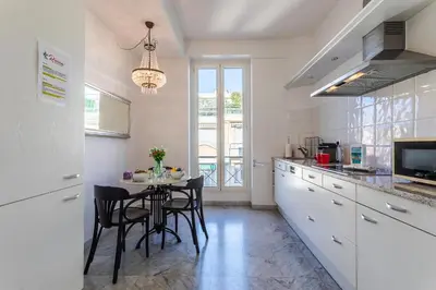 a kitchen with a table and chairs in a kitchen at Ambassador Palace AP2095 by Riviera Holiday Homes in Nice
