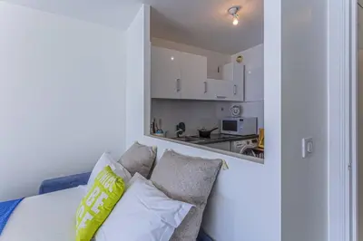 a living room with a couch and a kitchen at MY CASA - PROM 199 - Spacious studio - Promenade - Sea View in Nice