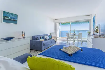 a bedroom with a bed and a living room at MY CASA - PROM 199 - Spacious studio - Promenade - Sea View in Nice