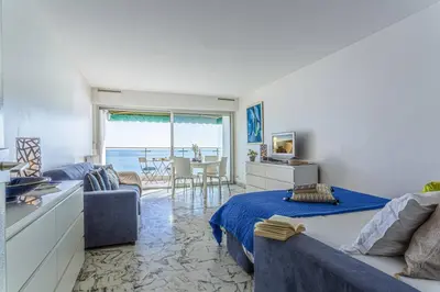 a bedroom with a bed and a living room at MY CASA - PROM 199 - Spacious studio - Promenade - Sea View in Nice