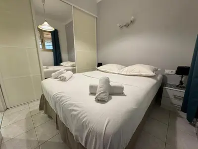 a bedroom with a large bed with towels on it at NEREIDES - Appartement 4 personnes avec Vue Mer exceptionnelle à Villefranche-sur-Mer in Villefranche-sur-Mer