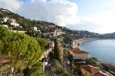 a town on a hill next to a body of water at NEREIDES - Appartement 4 personnes avec Vue Mer exceptionnelle à Villefranche-sur-Mer in Villefranche-sur-Mer
