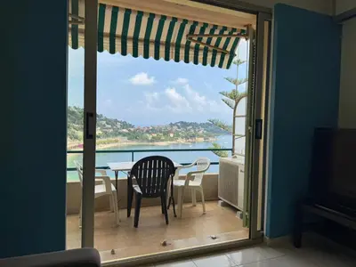a balcony with a table and chairs and a view of the ocean at NEREIDES - Appartement 4 personnes avec Vue Mer exceptionnelle à Villefranche-sur-Mer in Villefranche-sur-Mer