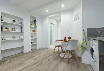 a kitchen and dining room with a table and chairs at Cosy Studio in the Old Town - St François Square in Nice