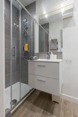 a bathroom with a white sink and a shower at Cosy Studio in the Old Town - St François Square in Nice
