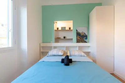 a bedroom with a blue bed with a mirror at The Big Flat - Hypercentre - Car park - Virtual tour in Nice