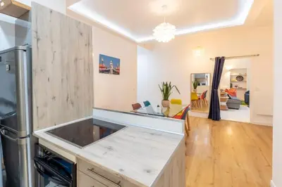 a kitchen with a counter top and a living room at The Big Flat - Hypercentre - Car park - Virtual tour in Nice