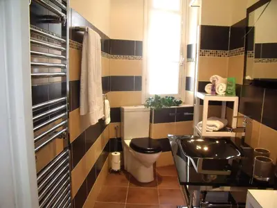 a bathroom with a toilet and a sink at Nizza - Boutique Wohnung - near Hotel Negresco in Nice