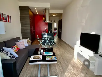 a living room with a couch and a table at PALAIS ELISABETH PROMENADE DES ANGLAIS in Nice