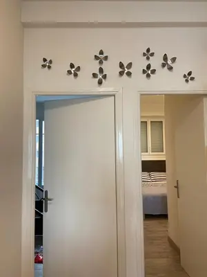 a room with a door with butterflies on the wall at PALAIS ELISABETH PROMENADE DES ANGLAIS in Nice