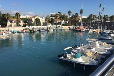 a group of boats are docked in a marina at Charmant appartement bord de mer, Plage in Cagnes-sur-Mer