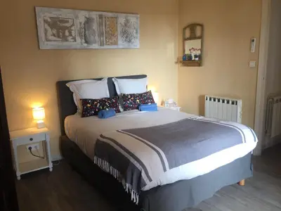 a bedroom with a large bed with pillows at Charmant appartement bord de mer, Plage in Cagnes-sur-Mer
