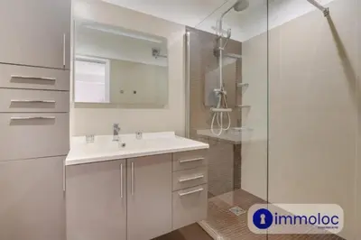 a white bathroom with a sink and a shower at Air-conditioned apartment in the Libération district in Nice