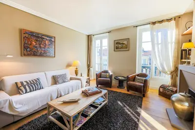 a living room with a white couch and a table at Vue Magenta AP4188 by Riviera Holiday Homes in Nice