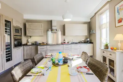 a kitchen with a dining table with chairs and a tableablish at Vue Magenta AP4188 by Riviera Holiday Homes in Nice