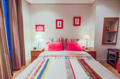 a bedroom with a large bed with red pillows at Vue Magenta AP4188 by Riviera Holiday Homes in Nice