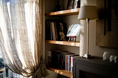 a book shelf filled with books next to a window at Vue Magenta AP4188 by Riviera Holiday Homes in Nice