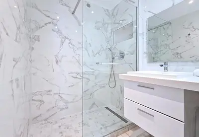 a white bathroom with a shower and a sink at Nestor&Jeeves - STUDIO ROYAL LUXEMBOURG - Central - Swimming pool on roof in Nice