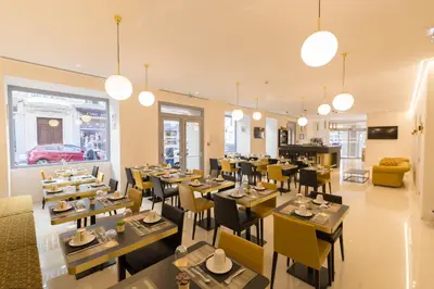 a restaurant with tables and chairs in a room at Hôtel Nice Azur Riviera in Nice