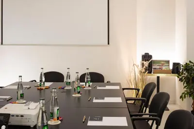 a meeting room with a table with bottles on it at Hôtel Nice Azur Riviera in Nice