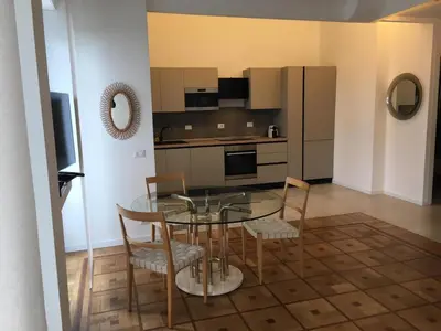 a kitchen with a glass table and chairs in a room at 91 Promenade des Anglais le stellamar in Nice