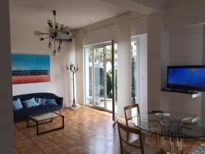 a living room with a glass table and a couch at 91 Promenade des Anglais le stellamar in Nice