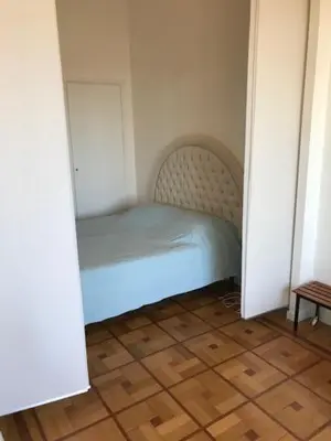 a small bedroom with a bed in a room at 91 Promenade des Anglais le stellamar in Nice
